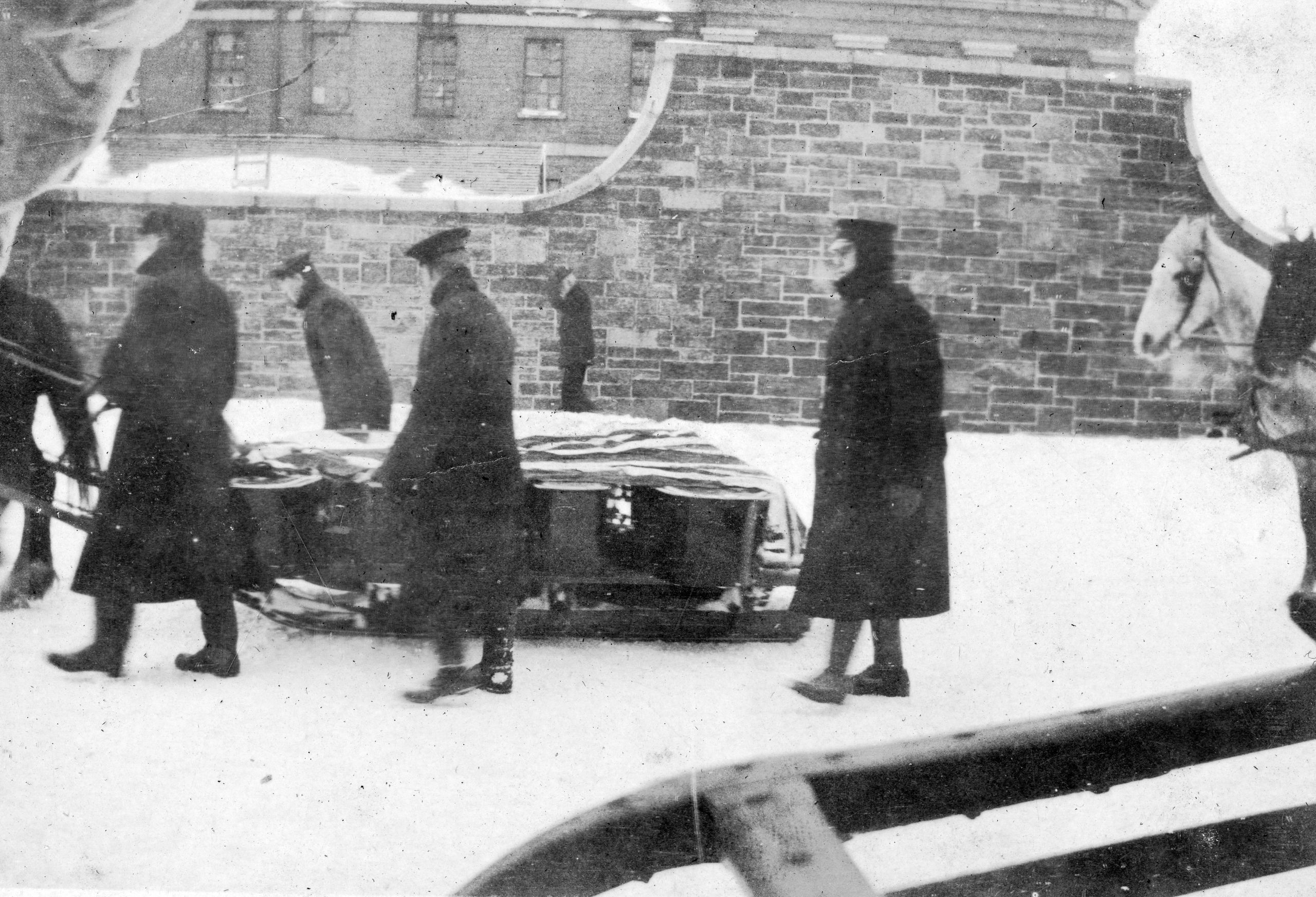 A sled of coffins containing those whose lives were lost in the Halifax Explosion being taken through the streets of Halifax in the days after. (Provincial Archives of New Brunswick P827-MS1-243)